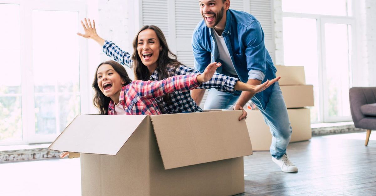 Young family moving houses having fun